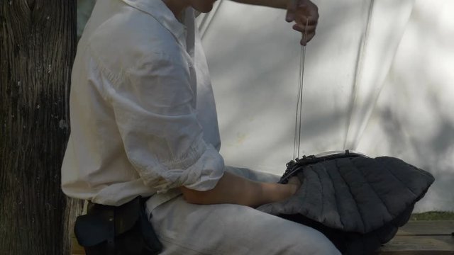 Close up of a craftsman working with leather during a middle ages reenacting