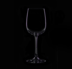 Silhouette of wineglass with violet illumination