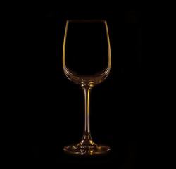 Silhouette of wineglass with yellow and brown illumination