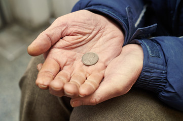 hands of beggar with penny coin begging for money 