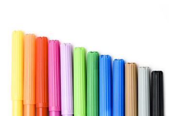 Colorful markers making forms on a white background