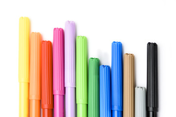 Colorful markers making forms on a white background