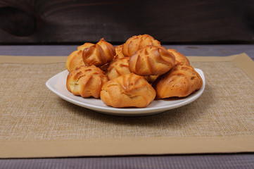 Fresh fragrant tasty biscuits on a fabric stand against the backdrop of an old tree