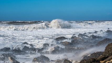 Stormy sea huge waves breaking near the coast
