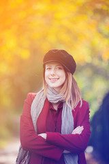 woman in red coat and hat have a rest in autum park