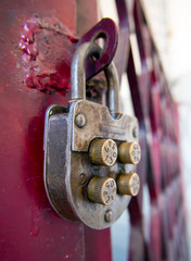 Vintage mechanical combination lock hanging on doors