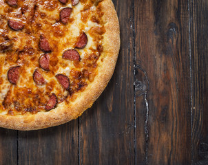 Texas pizza on rustic, vintage style wood background.