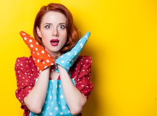 Young redhead housewife with gloves