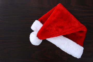 Obraz na płótnie Canvas Santa hat laying on a table top Christmas concept