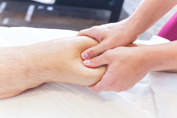 Therapist Giving Leg Massage In Spa manipulation of a calf muscle
