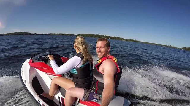 gopro seadoo male passenger smiles at camera while pretty girl drives