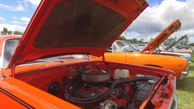 walking along classic muscle cars open engine bays gimbal 4k