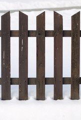 Old wooden fence surrounded by snow. Christmas and winter concept.