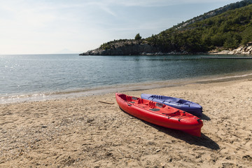 Fototapeta na wymiar two plastic kayak on beach