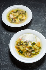 Soup with Mushrooms and chicken on stone background