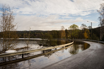 Flooded road. Flooding from the river Tovdalselva in Drangsholt in Kristiansand, Norway - October 3, 2017.