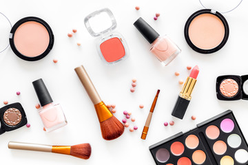 Cosmetics set with beige and nude tones for natural makeup on white background top view