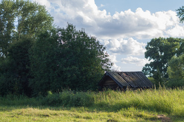 house in the village near the pond in the summer heat