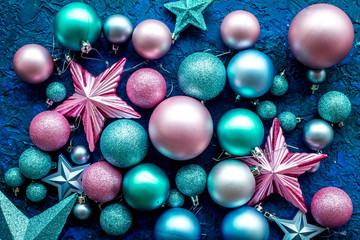 Balls and stars pattern to decorate christmas tree on blue background top view