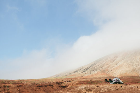 Friends Building a Camping Downstream of a Mountain
