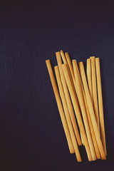 bread sticks on black stone surface