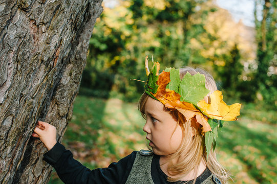 Portrait Of Young Child With Leaf Crown, Autumn Concept