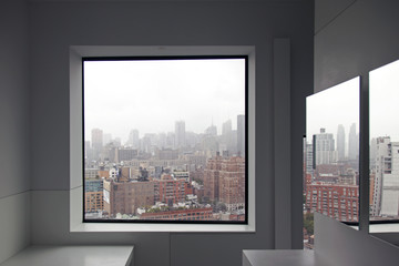 Fototapeta premium A view of New York City skyline from a window and a reflection on the mirror