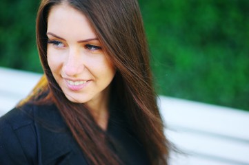 Fototapeta premium Portrait of beautiful smiling Caucasian white girls on blurred green background. A woman natural beauty with long hair, selective focus, close-up.
