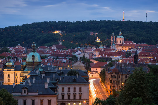 View of old buildings at the Mala Strana District (Lesser Town) and Petrin Hill in Prague, Czech Republic, at dusk.