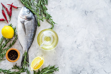 Preparing dorado with spices rosemary, pepper, chili, lemon. Grey background top view copyspace