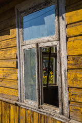 Old wooden house with a broken window