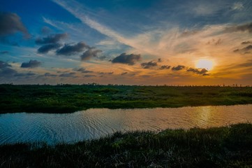 Fototapeta na wymiar boats and Sunset in the Swamp