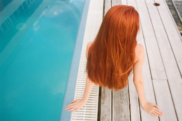 Back view of the woman with extremely long ginger hair