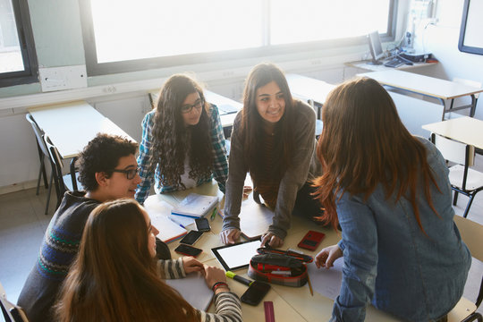 Young students doing teamwork at the classroom