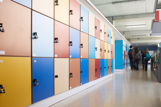 School hall with lockers and group of students walking away