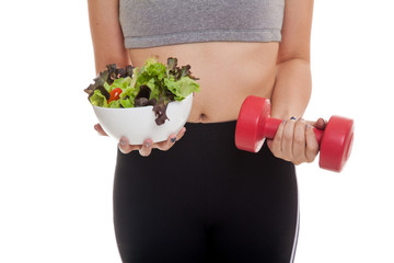 Asian healthy girl with dumbbell and salad.