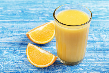 Cut orange and a glass of juice