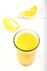 Cut orange and a glass of juice