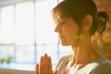 close up of yogi woman meditating at yoga studio