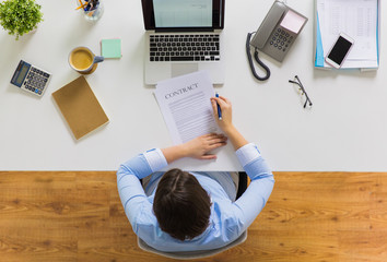 businesswoman signing contract document at office