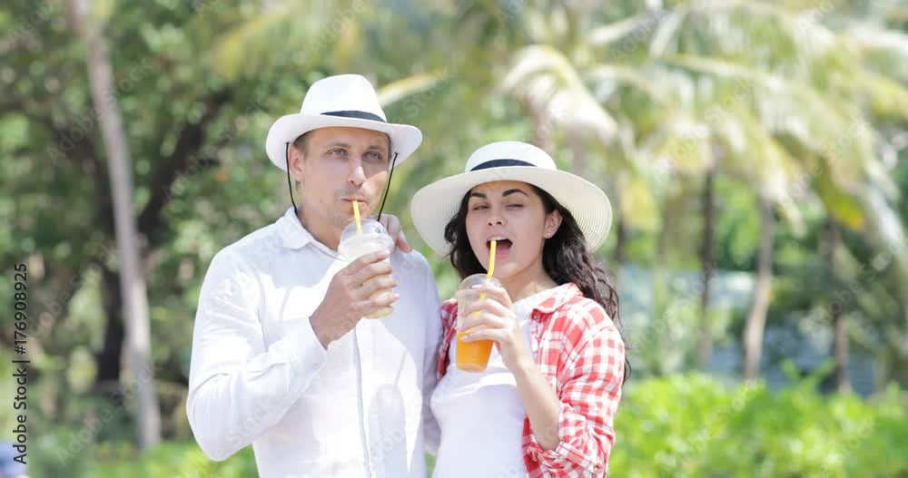 Canvas Prints Couple Talking Drink Juice Under Palm Trees, Happy Man And Woman Tourist Communication On Tropical Vacation Slow Motion 60