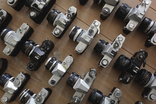 Vintage analog cameras on the wooden floor