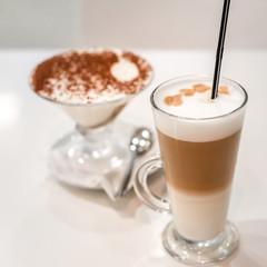 exquisite dessert tiramisu in a glass, and coffee latte, cafe, place for text