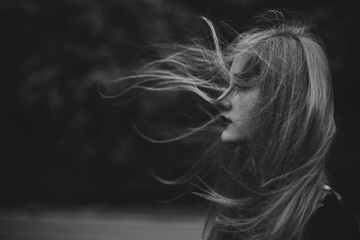 Young woman with hair blowing in the wind