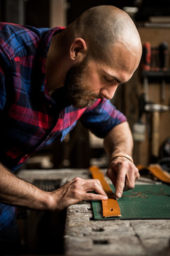Man cutting edges of a belt