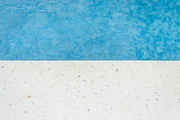 Swimming pool edge at the sunny day. Vacation background. Copy Space