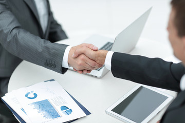 closeup .handshake of business partners above the Desk