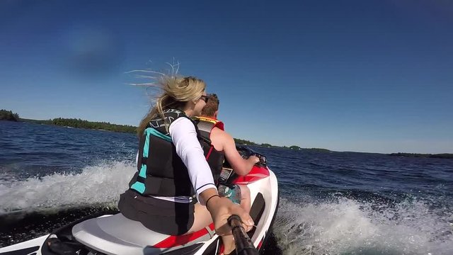 pretty girl having fun on back of seadoo selfie