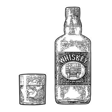 Whiskey glass with ice cubes and bottle label with barrel