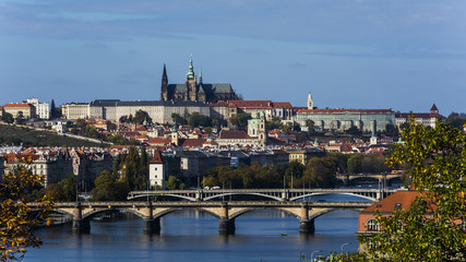 Obraz premium Lighten Prague during nice sunny day. Clear blue sky over czech landmarks.